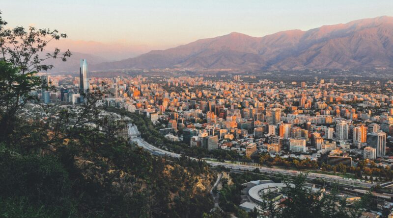 Breathtaking view of Santiago, Chile's skyline framed by mountains at sunset.